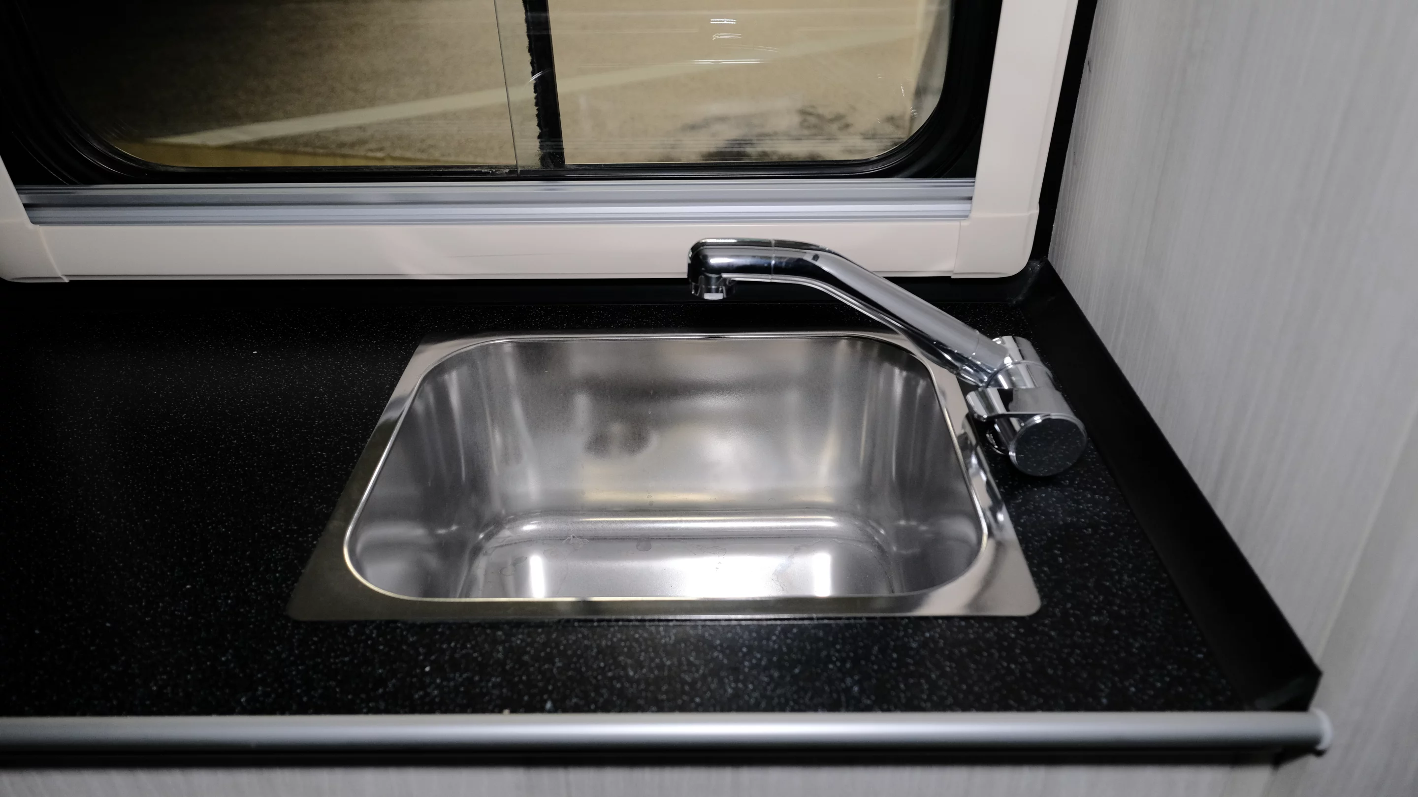 Sink with adjustable faucet