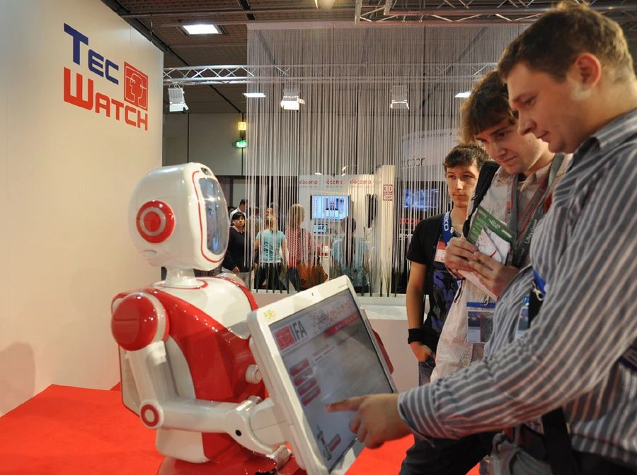 Visitors at IFA 2012 interact with Future Robot's service robot FURO.