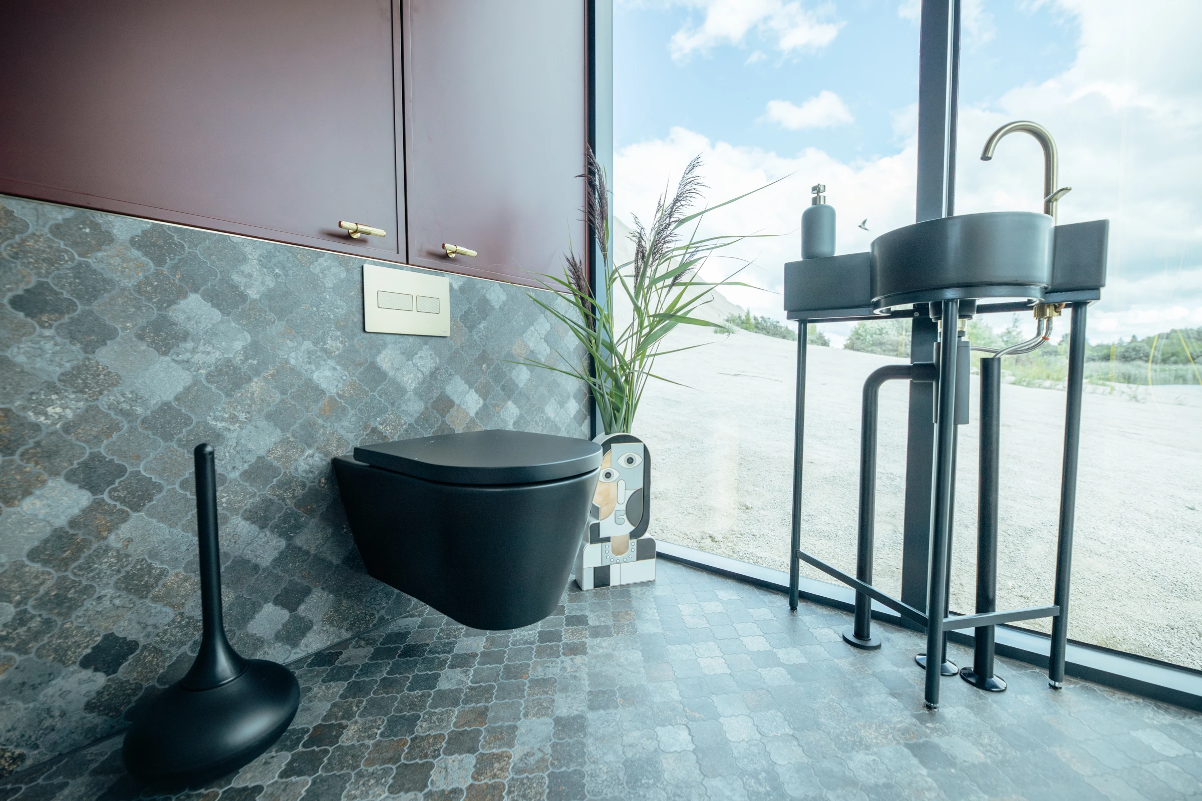 The Golden House's bathroom includes a flushing toilet, sink, and a shower