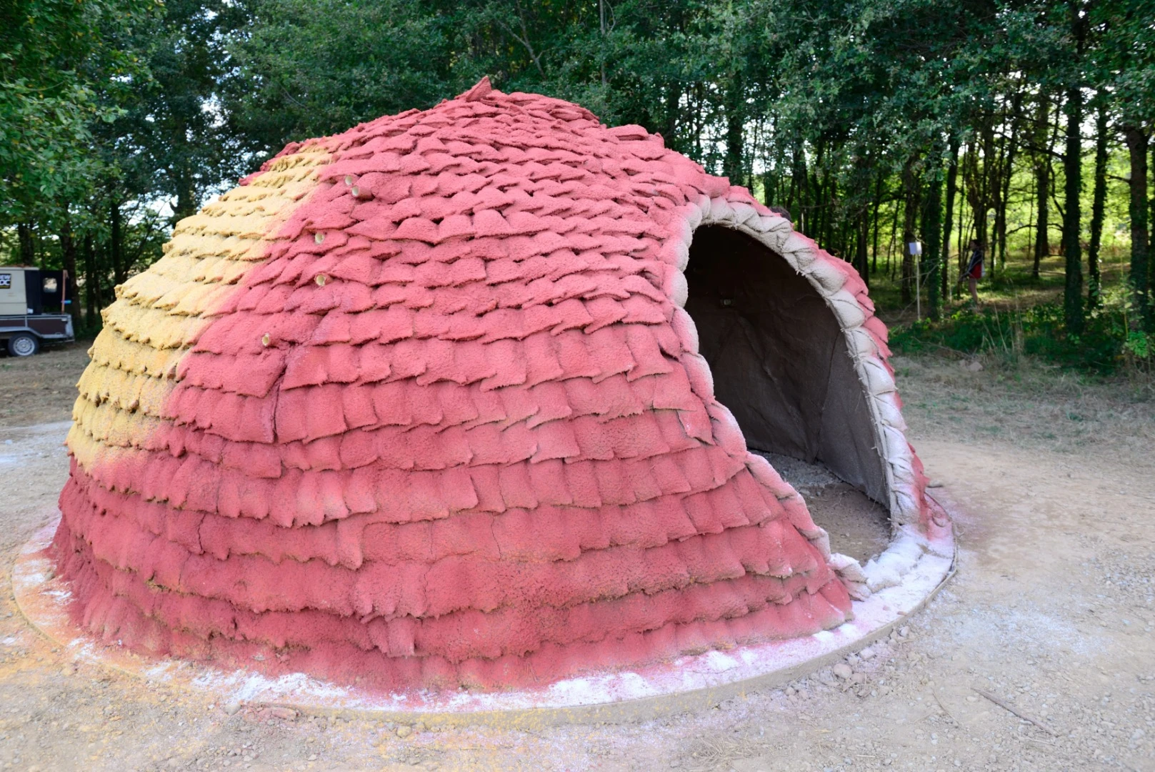 A dome shelter finished in biomaterials, applied by a drone