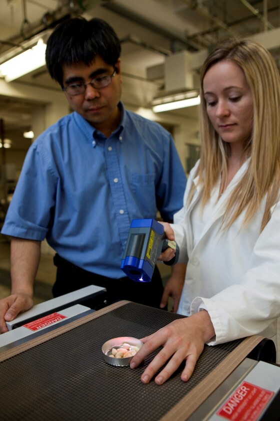 Wade Yang, left, has used pulsed light to remove 80 percent of the allergens from a whole peanut (Photo: UF/IFAS file photo)
