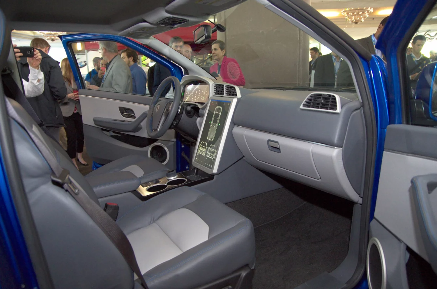 Utilitarian cockpit sports an oversized Tesla-esque tablet in the center console