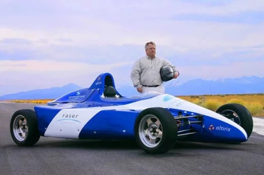 Kraig Higginson, Raser's Executive Chairman poses with Raser's Edge deomstration vehicle for the company's elecrifying electric motor technology