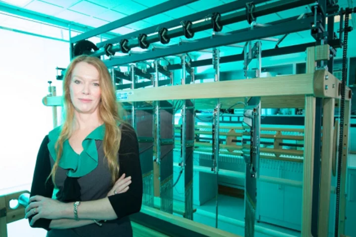 Professor Melissa Knothe Tate with the computer-controlled jacquard loom used to create a "smart" fabric that mimics the properties of periosteum