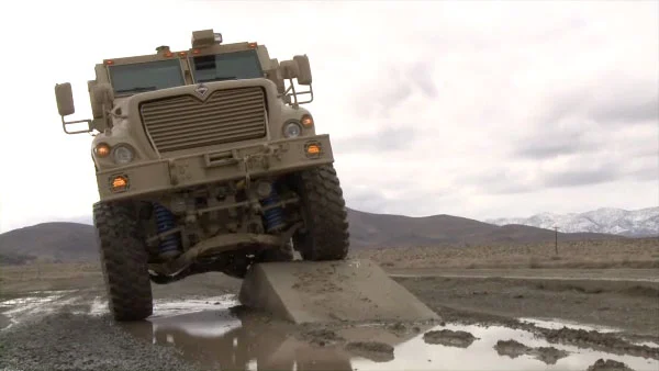A military-spec MXT APC shows off its MaxxPro semi-active suspension