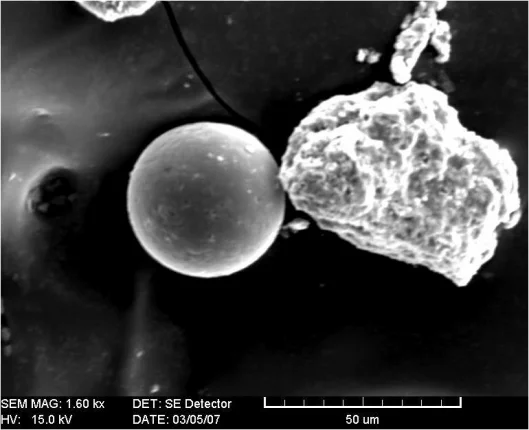 Larger particle Fe-oxide spheres produced by combustion, collected with a double-sided tape collector (Photo: Rachel Housen, Whatcom Middle School/Bellingham High School)