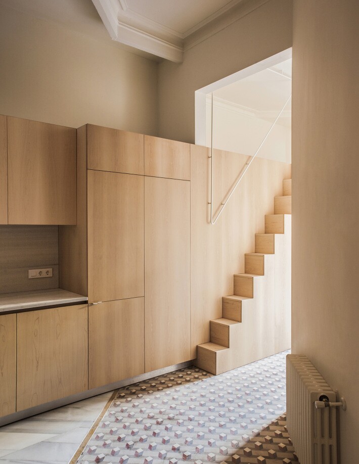 Anna and Eugeni Bach Architects built the central wooden functional wall to provide the home with all the services it needs without stealing space from the home's principal rooms
