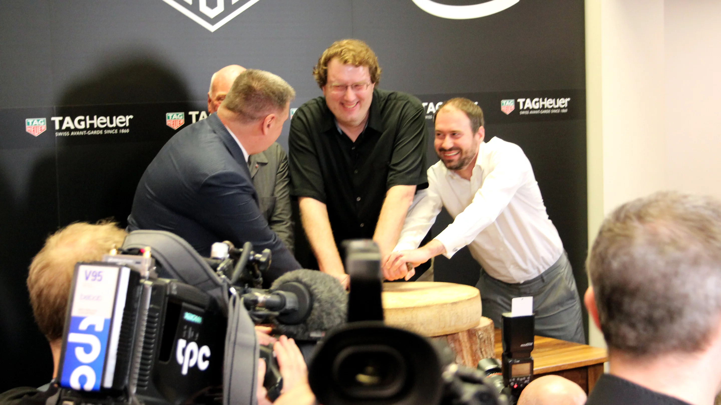 Representatives from Google and Intel cutting a wheel of cheese produced by Tag Heuer CEO Jean-Claude Biver's very own cows (Photo: Chris Wood/Gizmag)