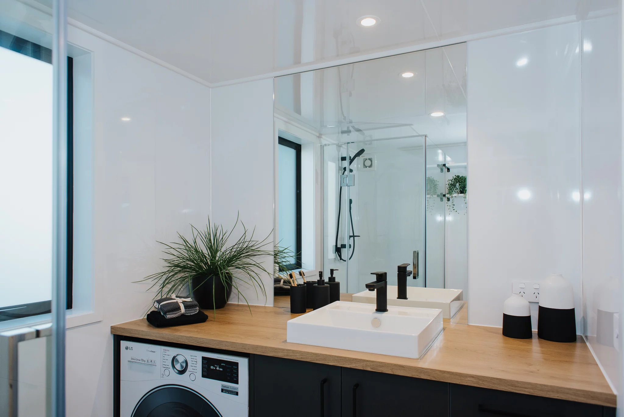 Scotty The Tiny House's bathroom contains a washer/dryer