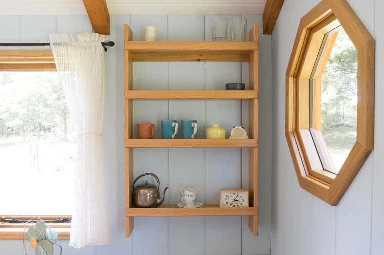 Furniture designed for the Shepherd Hut includes a folding hardwood desk, a butler's cupboard and countertop, a sofa bed, bunk beds, shelving units, and a bookcase (Photo: Güte)