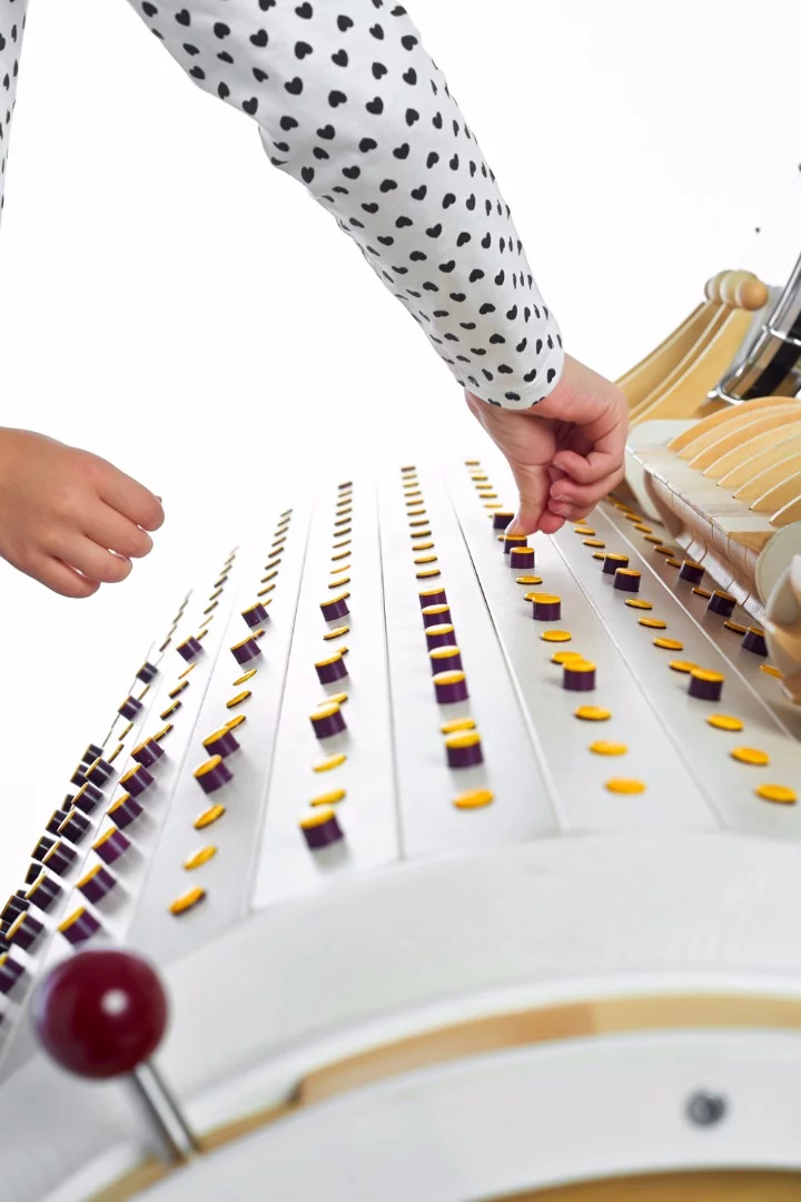 A Musicon melody is programmed by pushing down buttons on the huge barrel, which then pop up to hit instrument levers as the barrel rotates