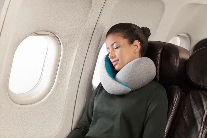 The Ostrich Pillow Go is a travel pillow that is fitted around the user's neck