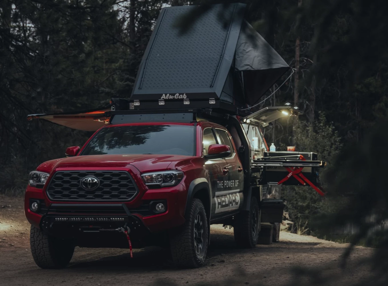 The first vehicle in Redarc's North American fleet, the custom Tacoma features a different style of pop-up camper, with a hardware-filled canopy below and a hardshell rooftop tent up above