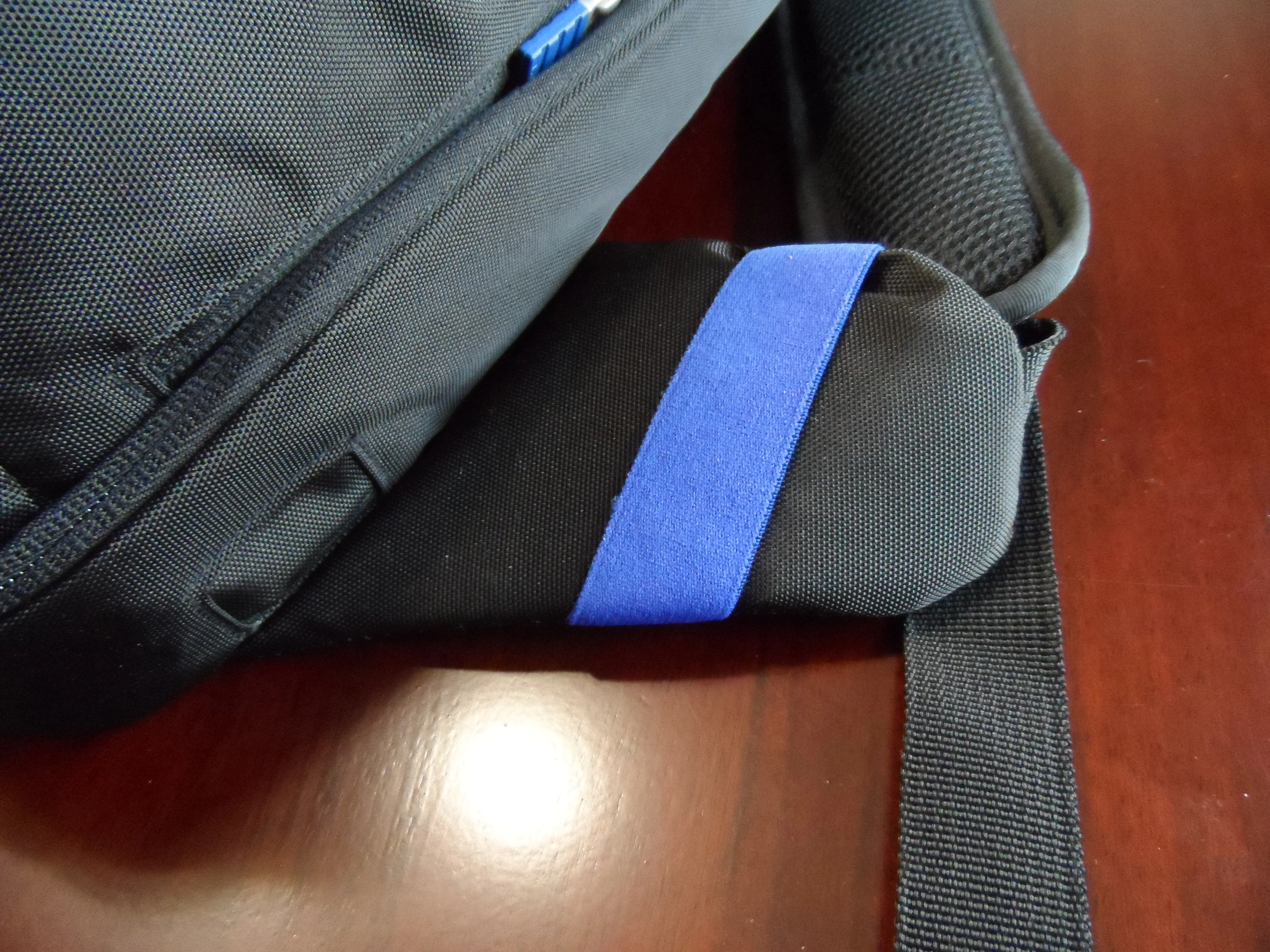 The blue strap keeps headphone cables in check