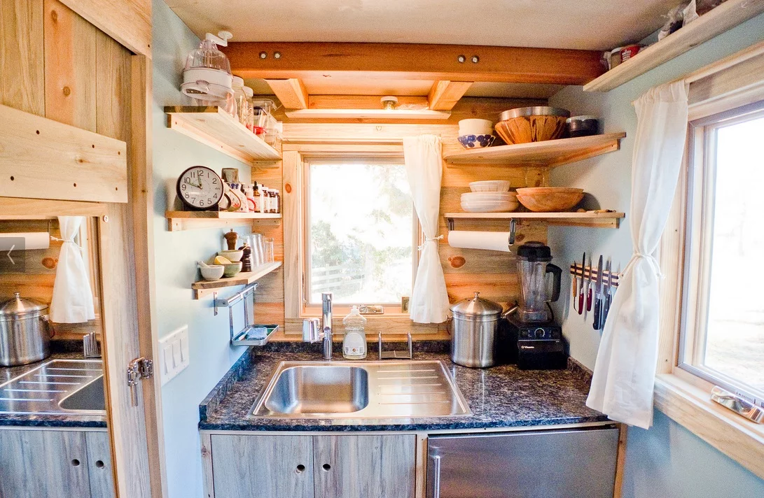 Shelving takes up the height of the kitchen walls
