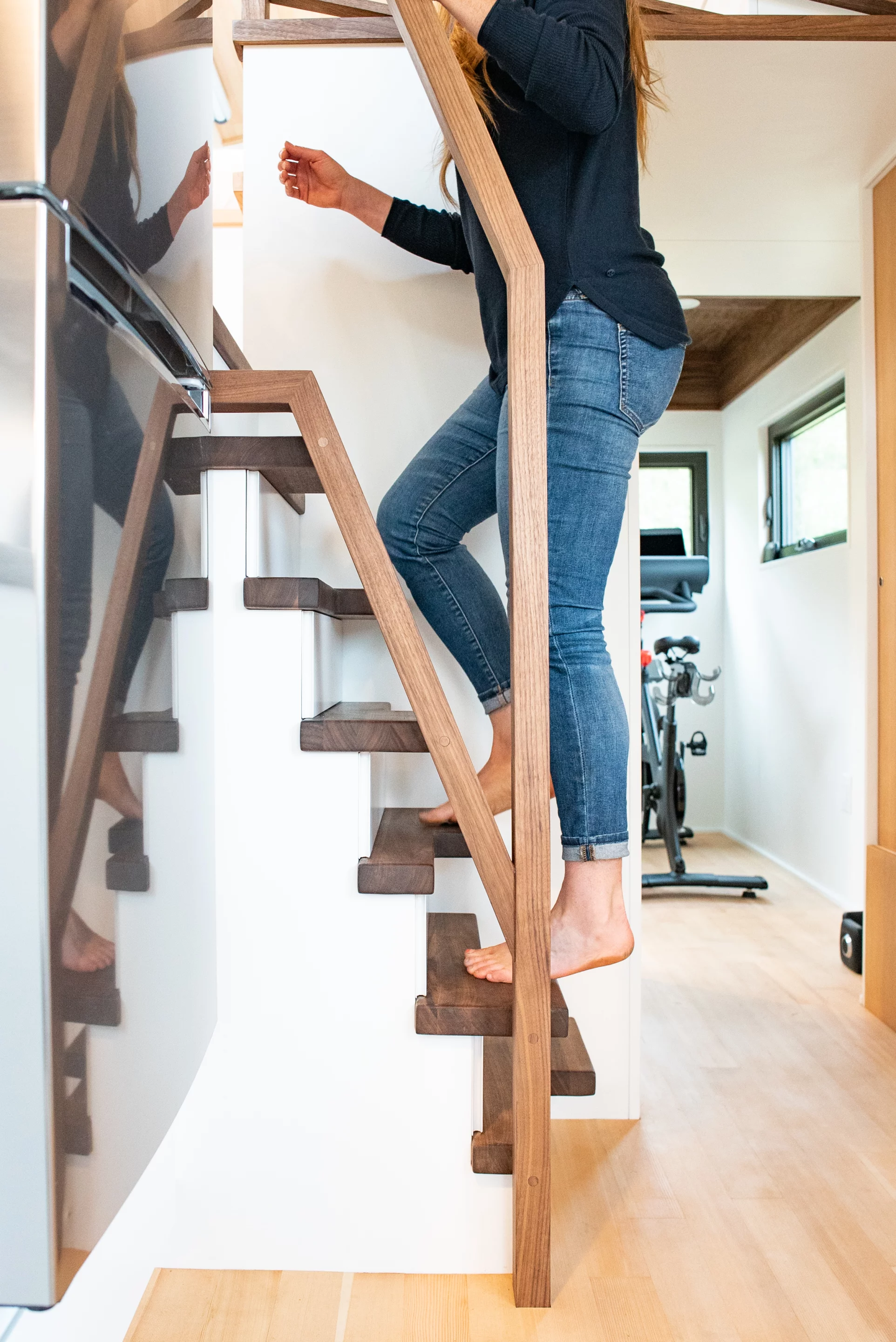 The Trahan Tiny House's loft bedroom is reached by an alternating tread staircase