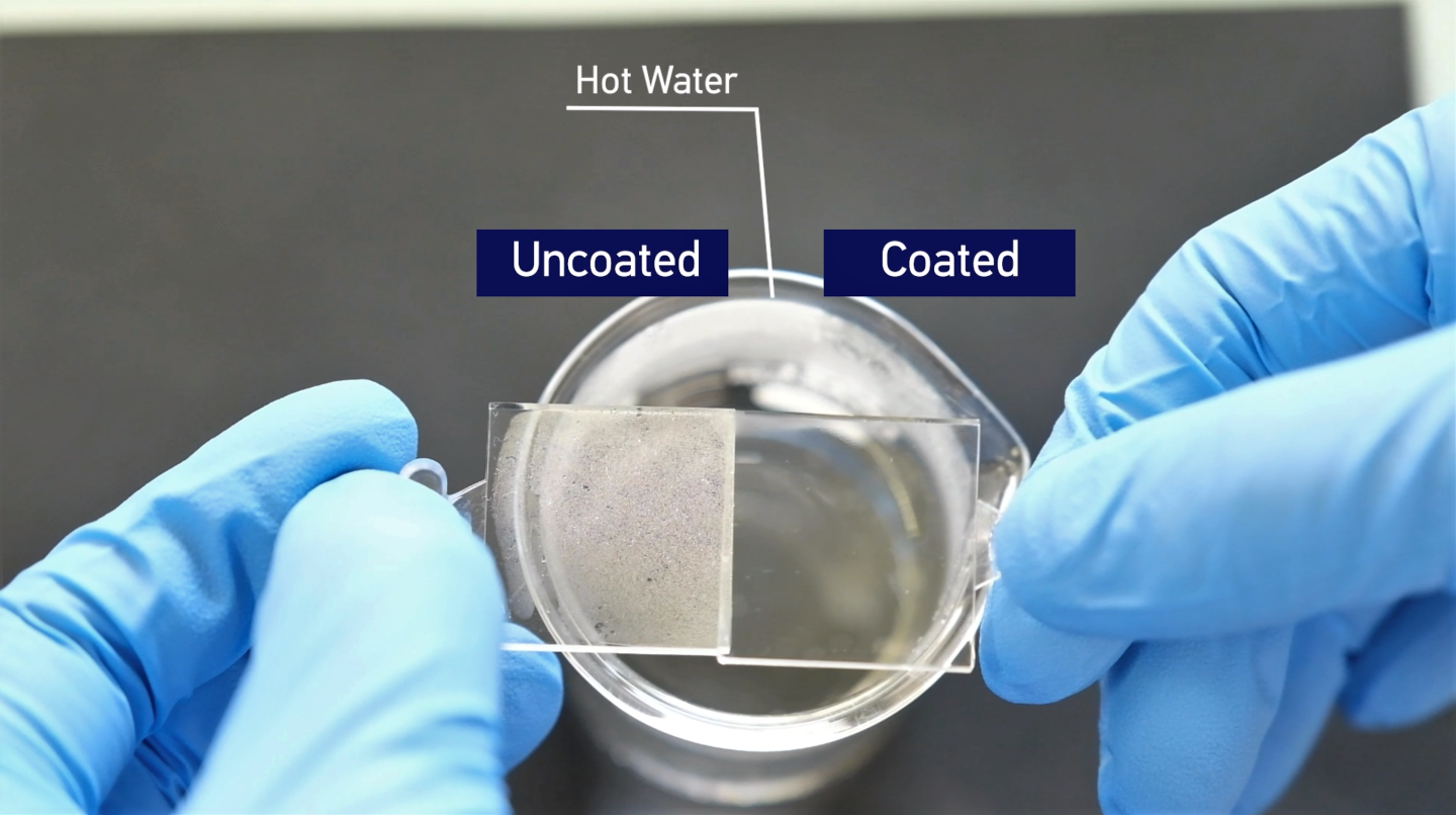 An untreated piece of plastic fogs up when placed over hot water (left), while a treated sample resists fogging