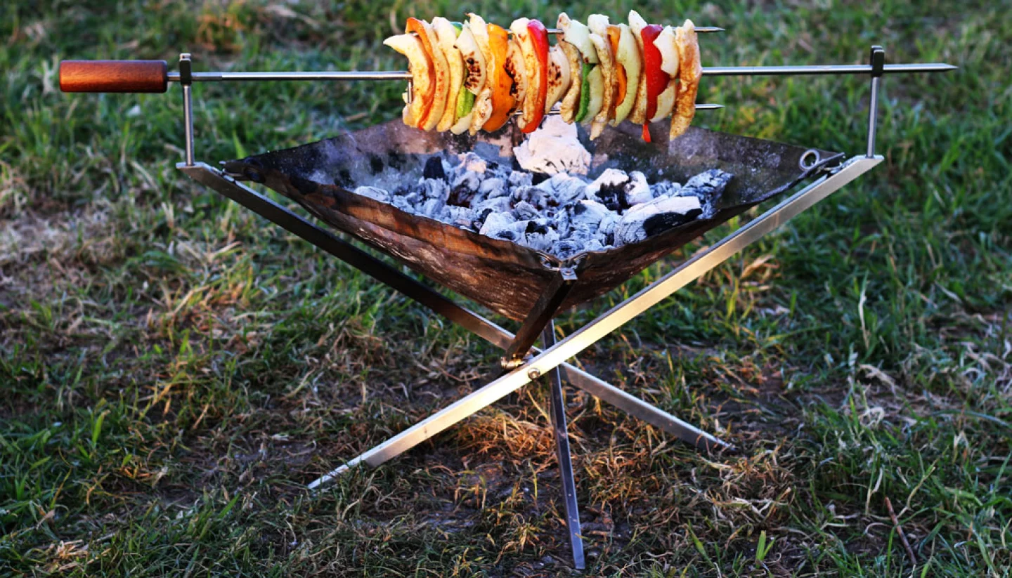 Rollable fire pit takes wood fire and grilling anywhere
