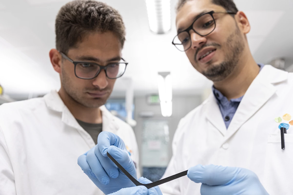 Liam Swanepole (left) and Abdullah Almansouri demonstrate the flexibility of the magnetic skin