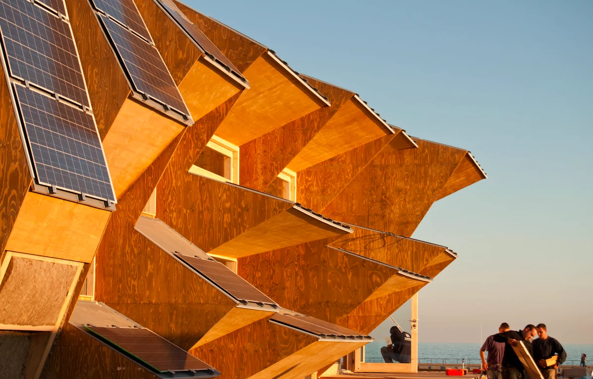 In a neat twist the same protrusions act as solar barriers during summer when the sun tracks a higher course across the sky, but let sunlight directly in during winter