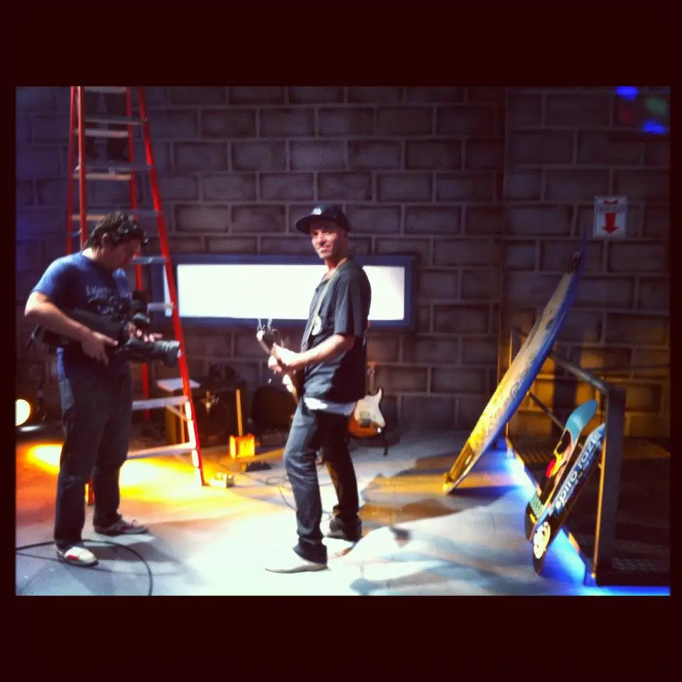 Gianfranco de Gennaro Gilmour posing for publicity shots with a Skate Guitar