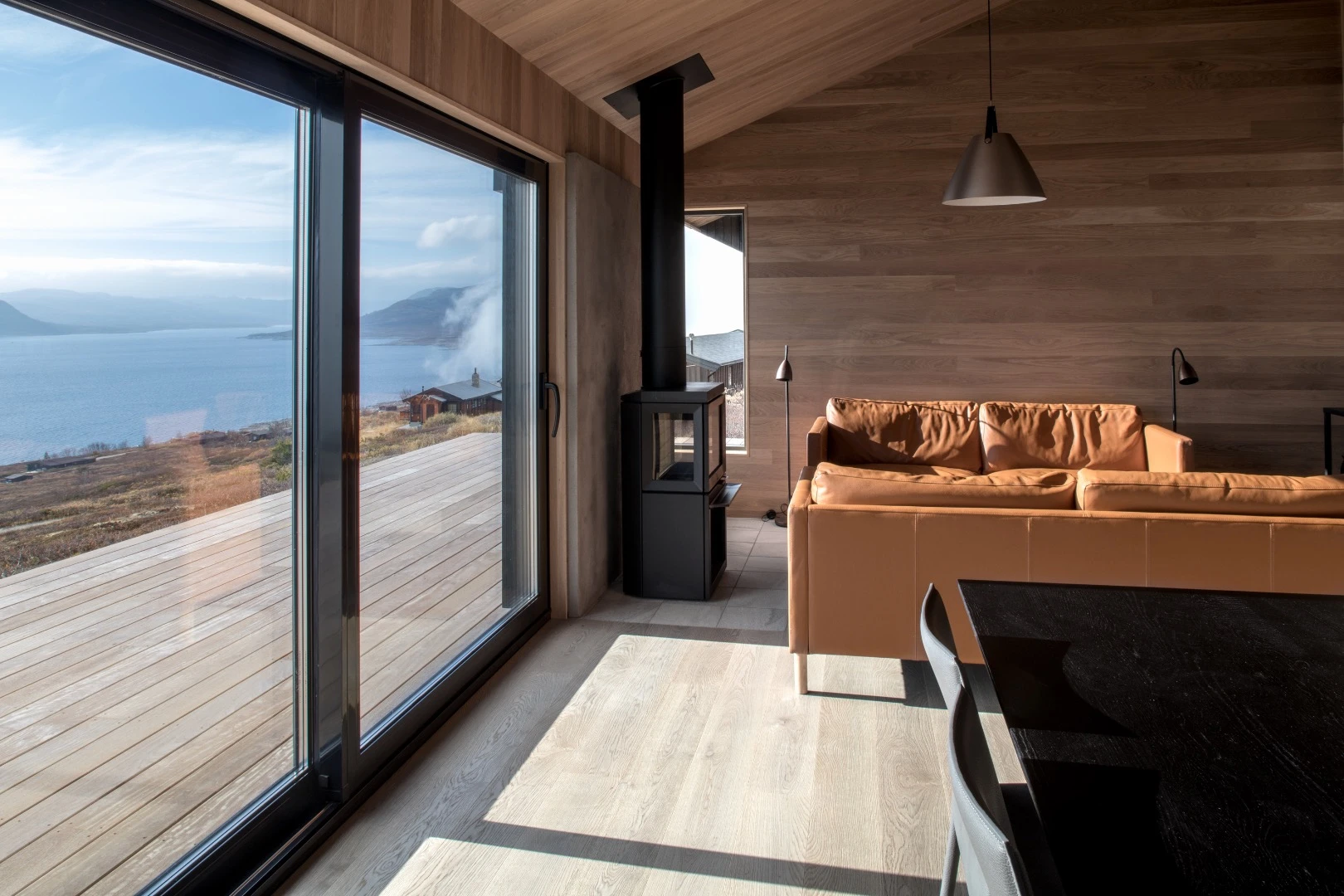 The Hooded Cabin's glazed front frames excellent views of the Norwegian landscape, including a lake below