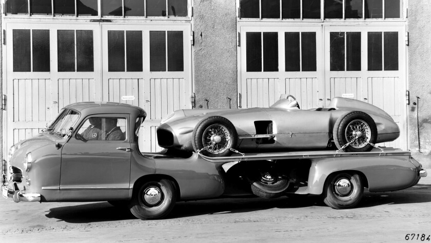 The auction car (or its identical 005 chassis sister) on the back of the famous Mercedes Race Transporter.