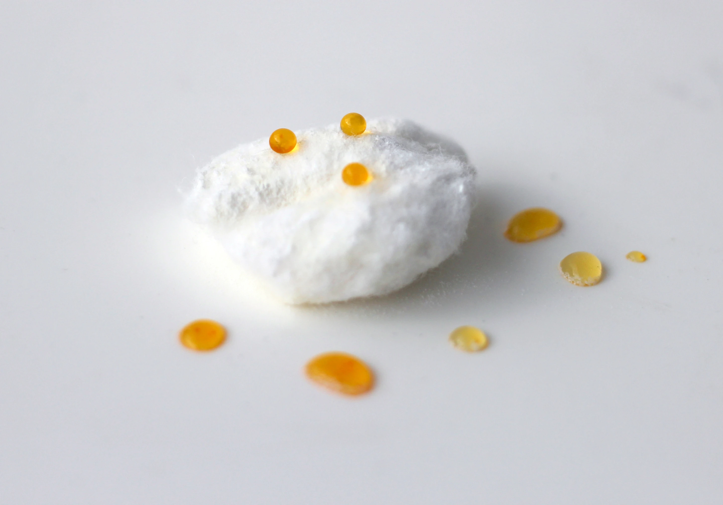 Dyed-water droplets sit on the surface of treated cotton wool (Photo: Oli Usher/UCL)