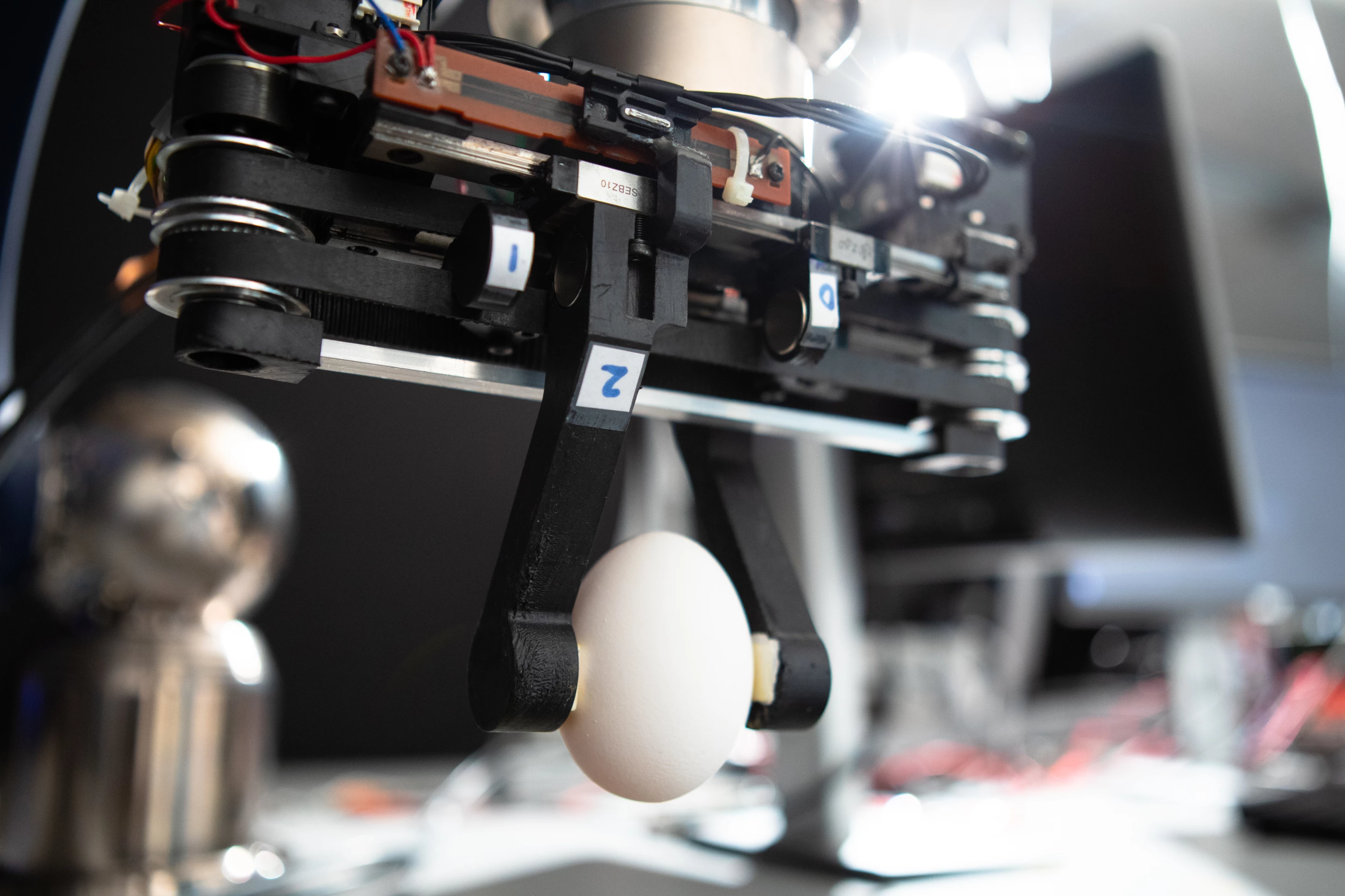 The prototype gripper grasps an egg