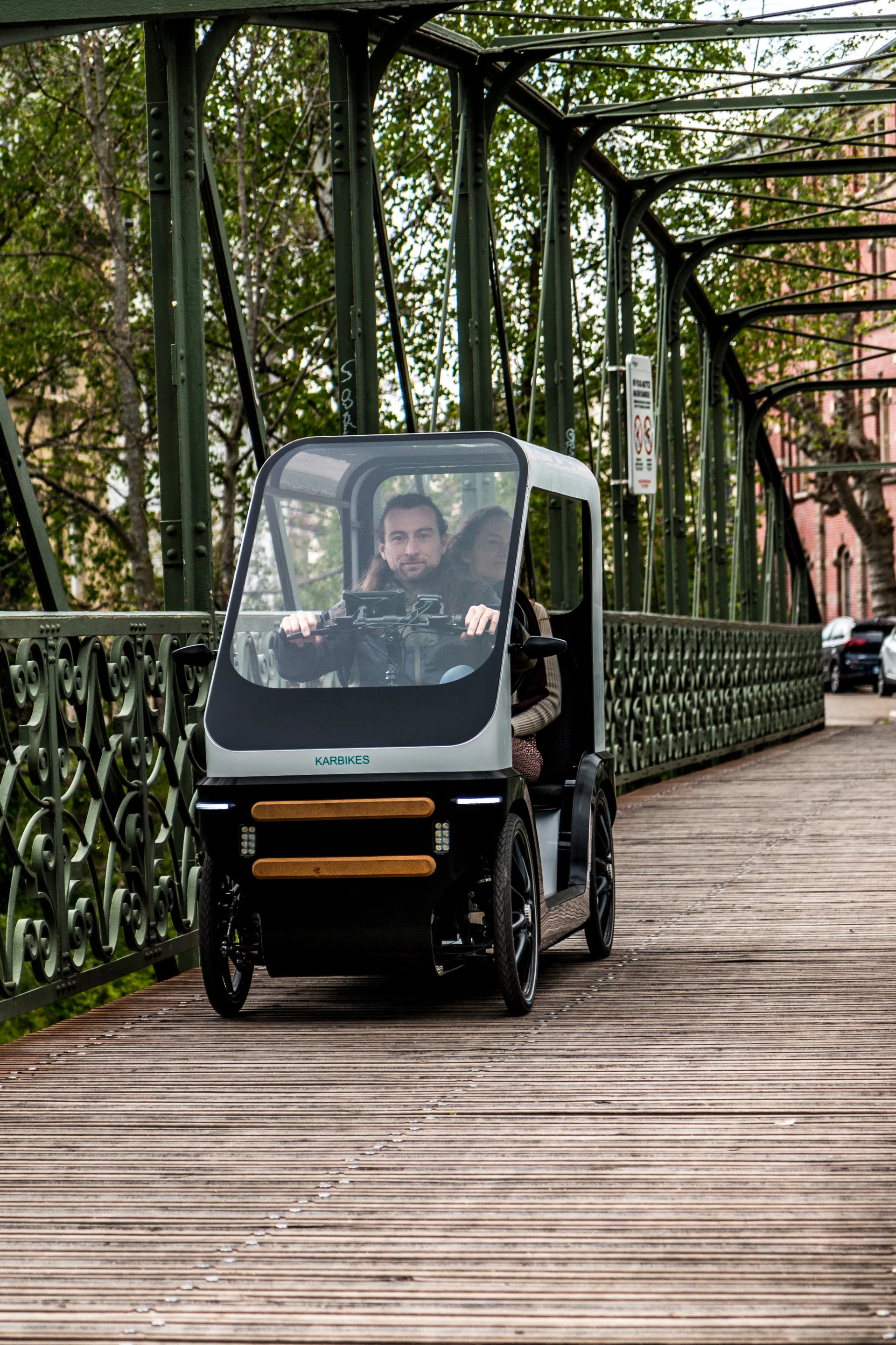 The Karbikes e-vehicle can be had with removable fabric doors for open or closed travel