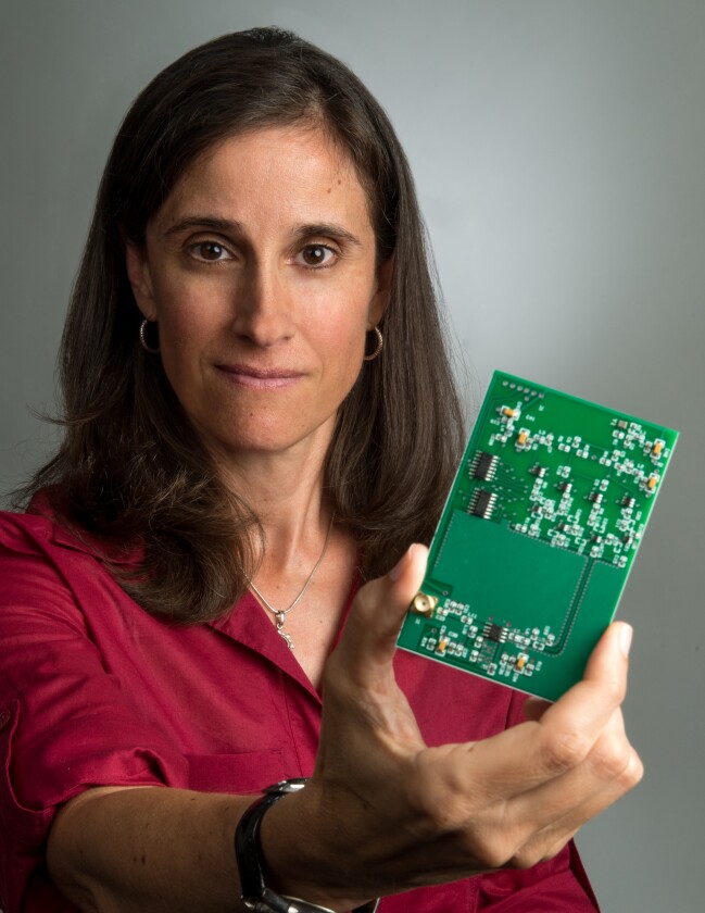 Lisa Mazzuca with new Search and Rescue Beacon circuit board