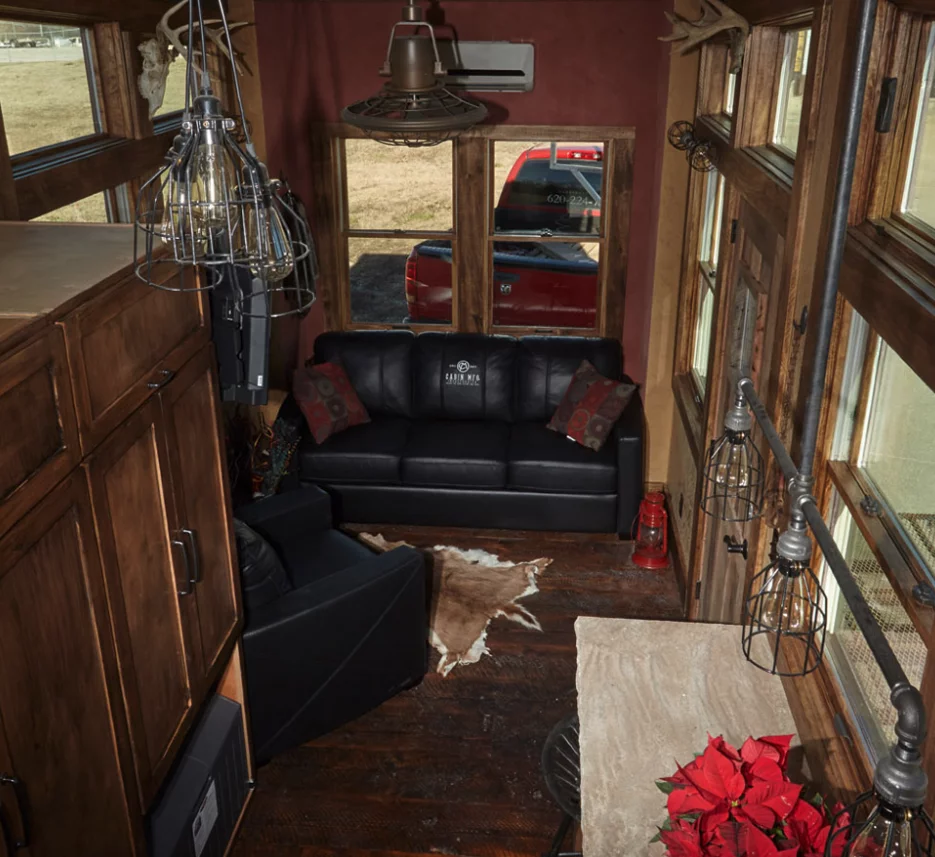 The lounge features a small sofa and a chair