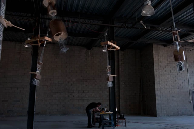 Hanging twenty feet above ground, the pendulums slowly swing back and forth (image from Pattern Studio)