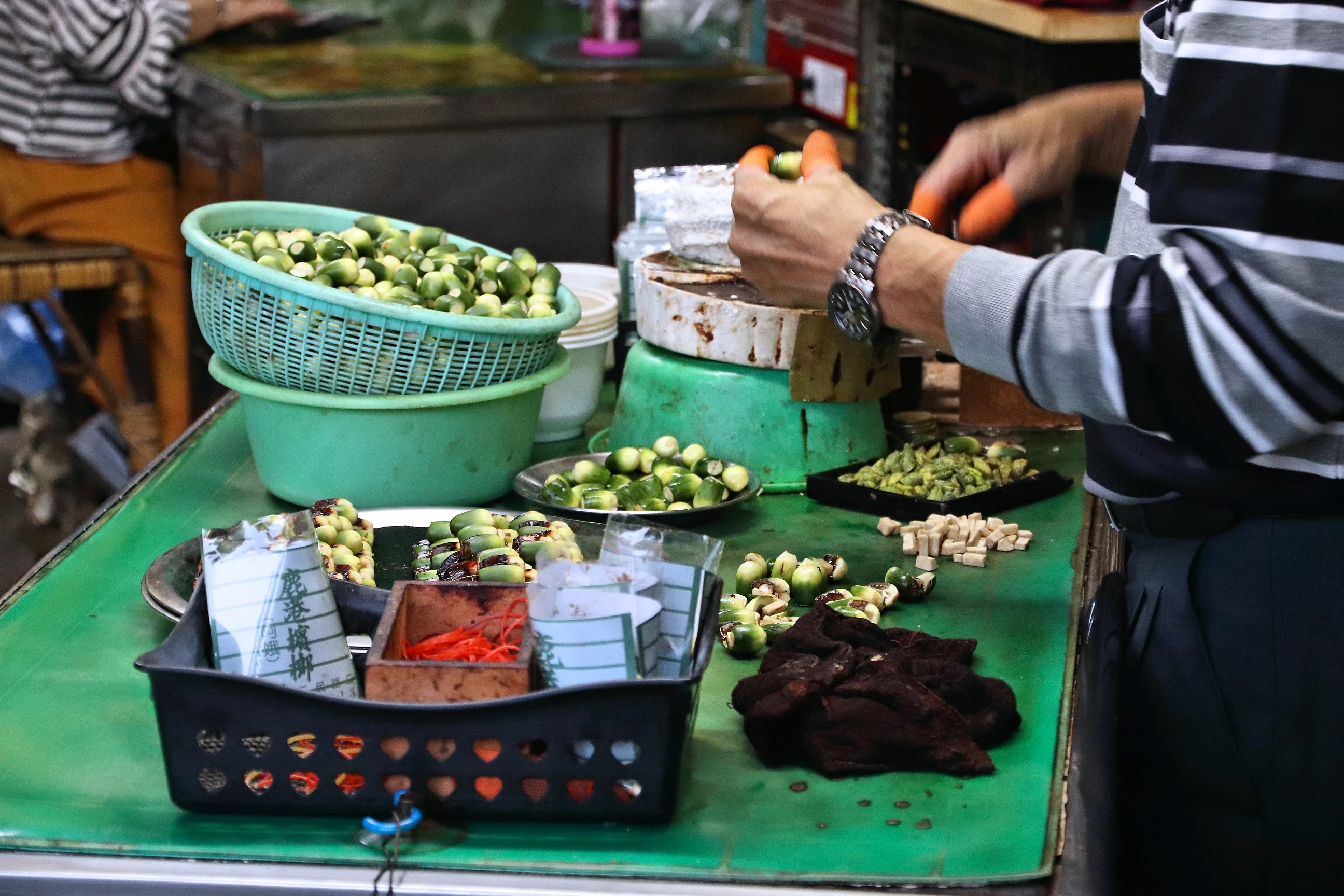 A street vendor in Taiwan prepares betel nuts for sale