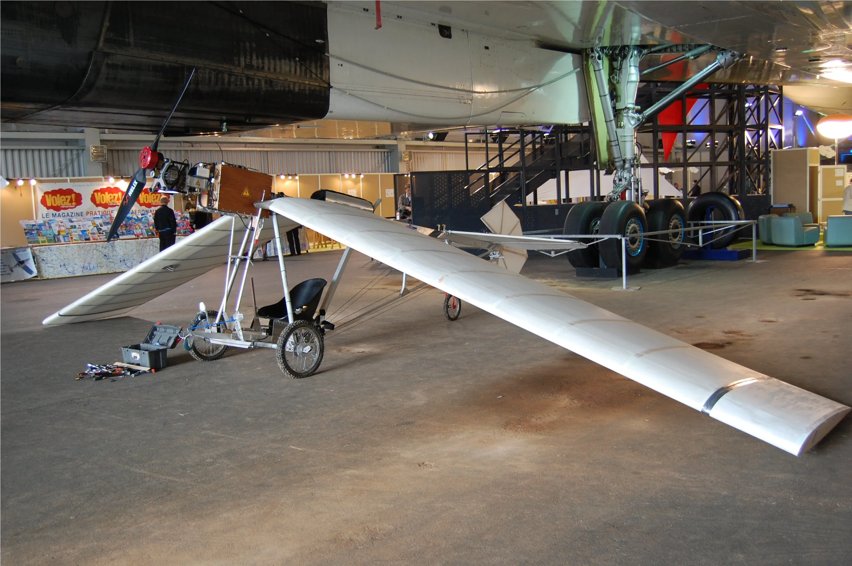 Under construction: the electric Demoichelle monoplane sitting underneath Concorde at the Green Air Show in Paris