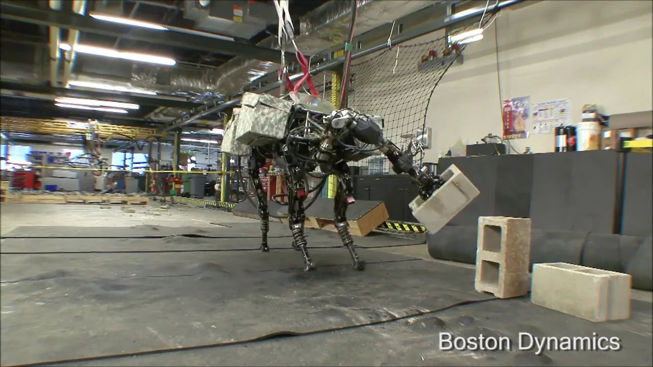 BigDog winds up to throw the cinder block