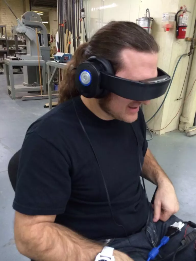 The headband can be pulled down over the eyes to project video images directly onto the wearer's retinas
