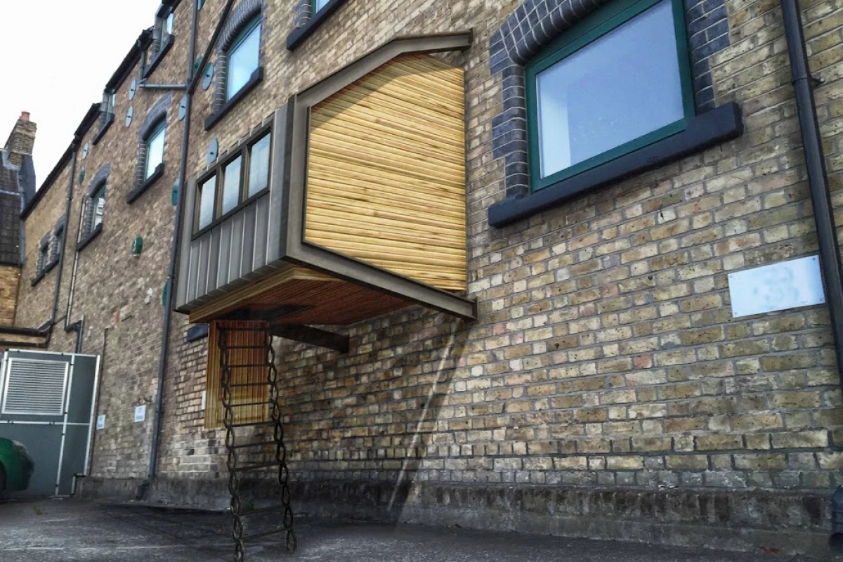 Each pod comprises two steel frame sections that attach to a wall at four points and then hold the structure together and in place