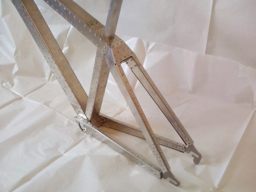 Using a CNC (computer numerical control) system, the main components of the frame are first cut from sheets of aluminum
