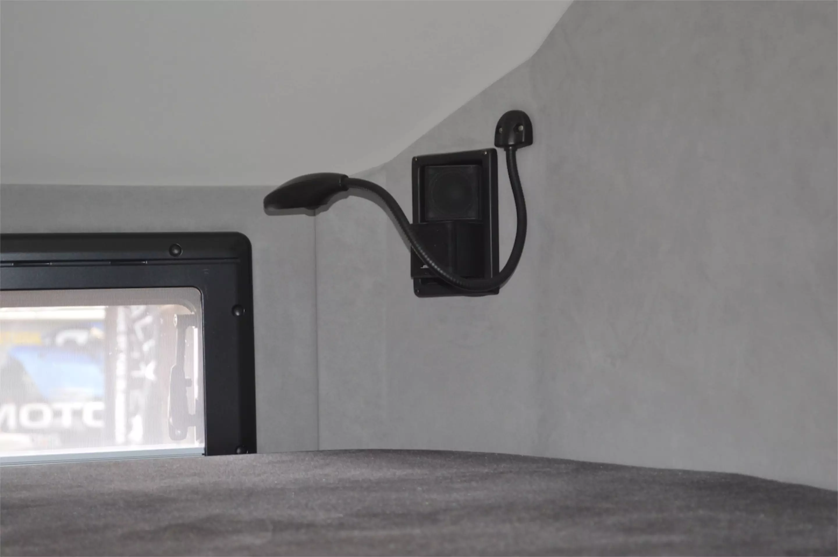 Lighting and Bose speakers mounted in the corner over the above-cab bed