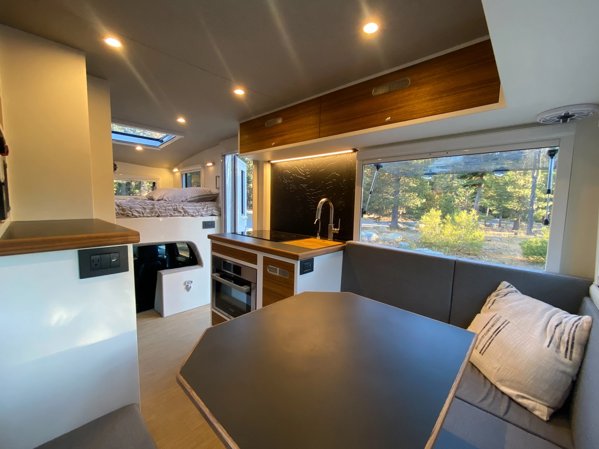 You'll have to pack your own grill if you prefer cooking outside, but the BCT has you covered indoors with a dual-burner cooktop, oven and microwave