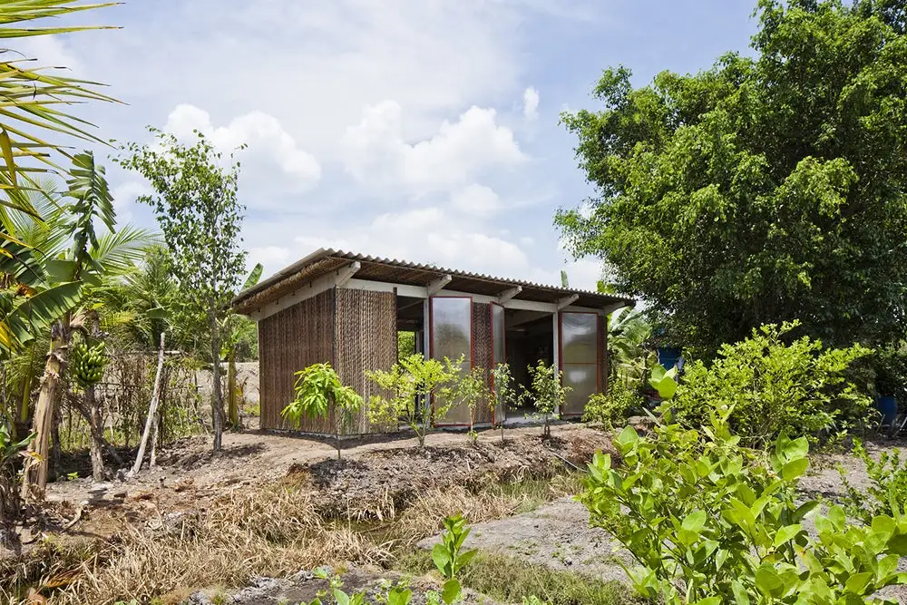 The S House by Vo Trong Nghia Architects comprises a pre-cast concrete frame and foundation that's bolted together with steel fixings, plus a cement roof. It also features steel doors and window frames, and easily-obtained local materials such as Nipa Palm leaf thatching and bamboo that are used to finish the home
