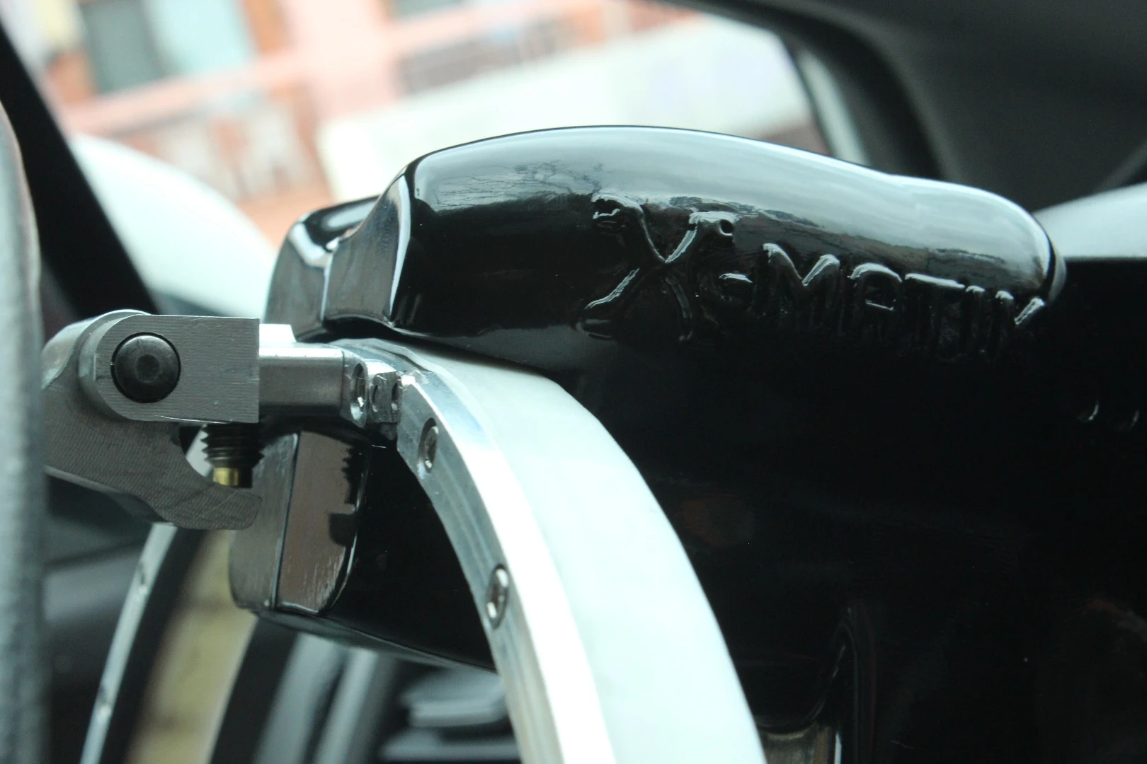 A close up of the steering wheel actuator, which moves along a track mounted behind the steering wheel