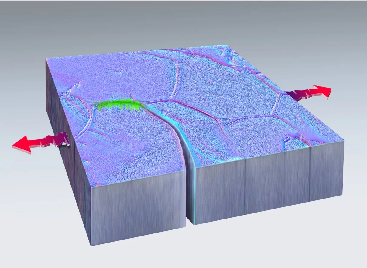 A computer model of a chunk of metal with a crack in it and an area in green showing where the metal has healed itself