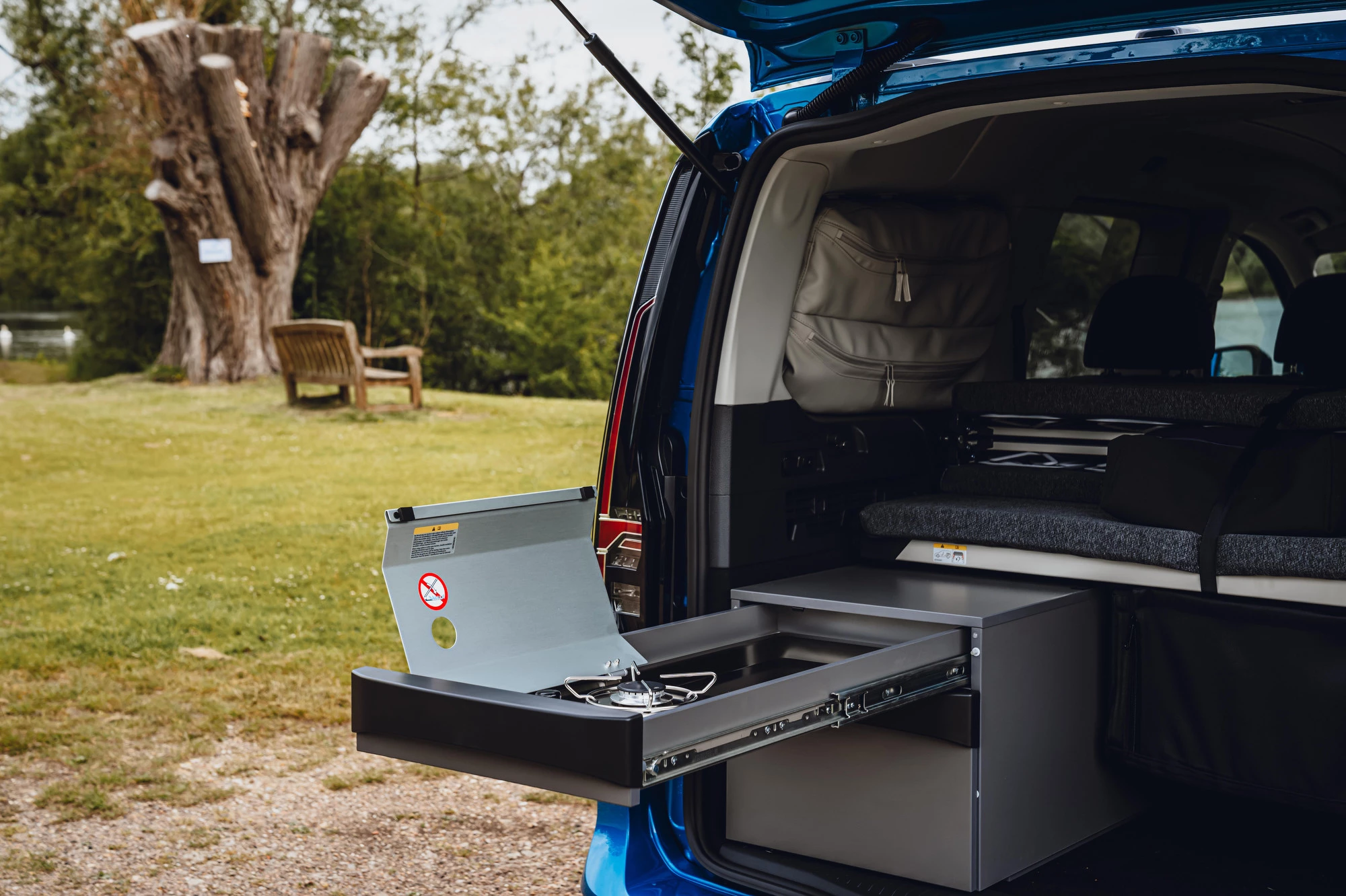 The VW Caddy California's slide-out kitchen has a single-burner stove, space for gas canister and utensils drawer