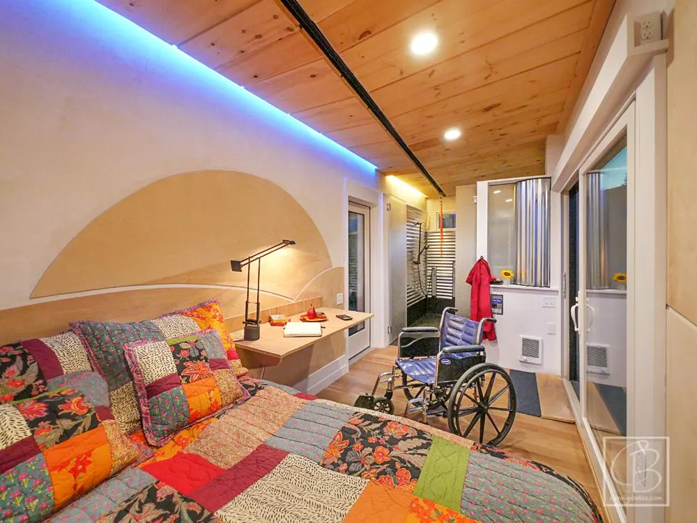 The Wheel Pad's interior layout is divided between a main living area with a bed to one side and a bathroom