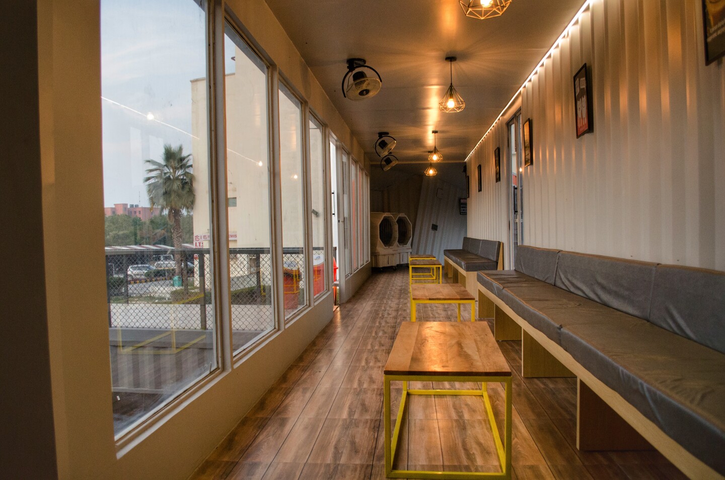 Café Infinity's interior decor suits the containers' utilitarian appearance and is finished in fiber cement board and gypsum paneling