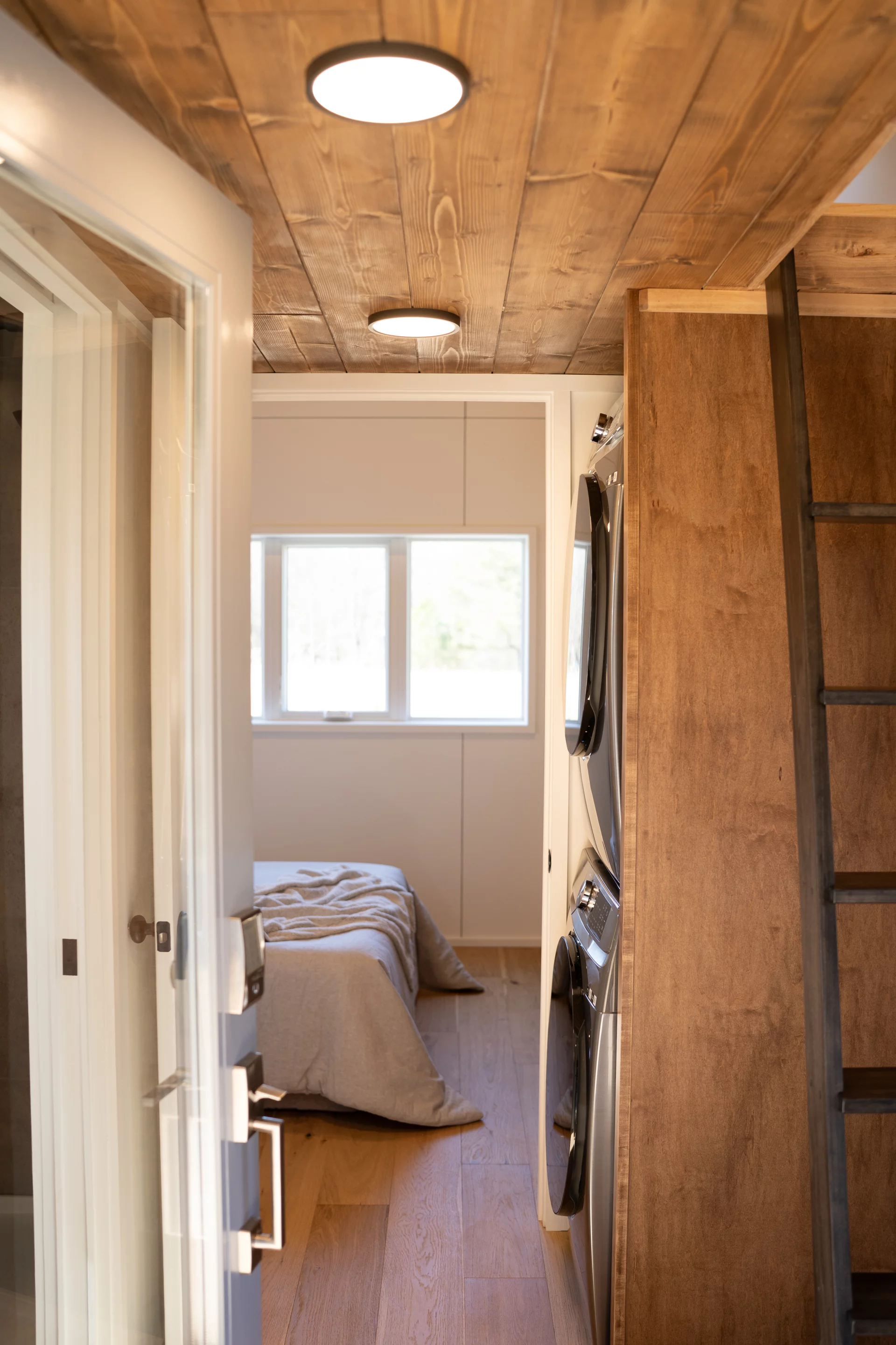 The Pisgah Park Model includes a main bedroom downstairs and an upstairs loft bedroom reached by ladder