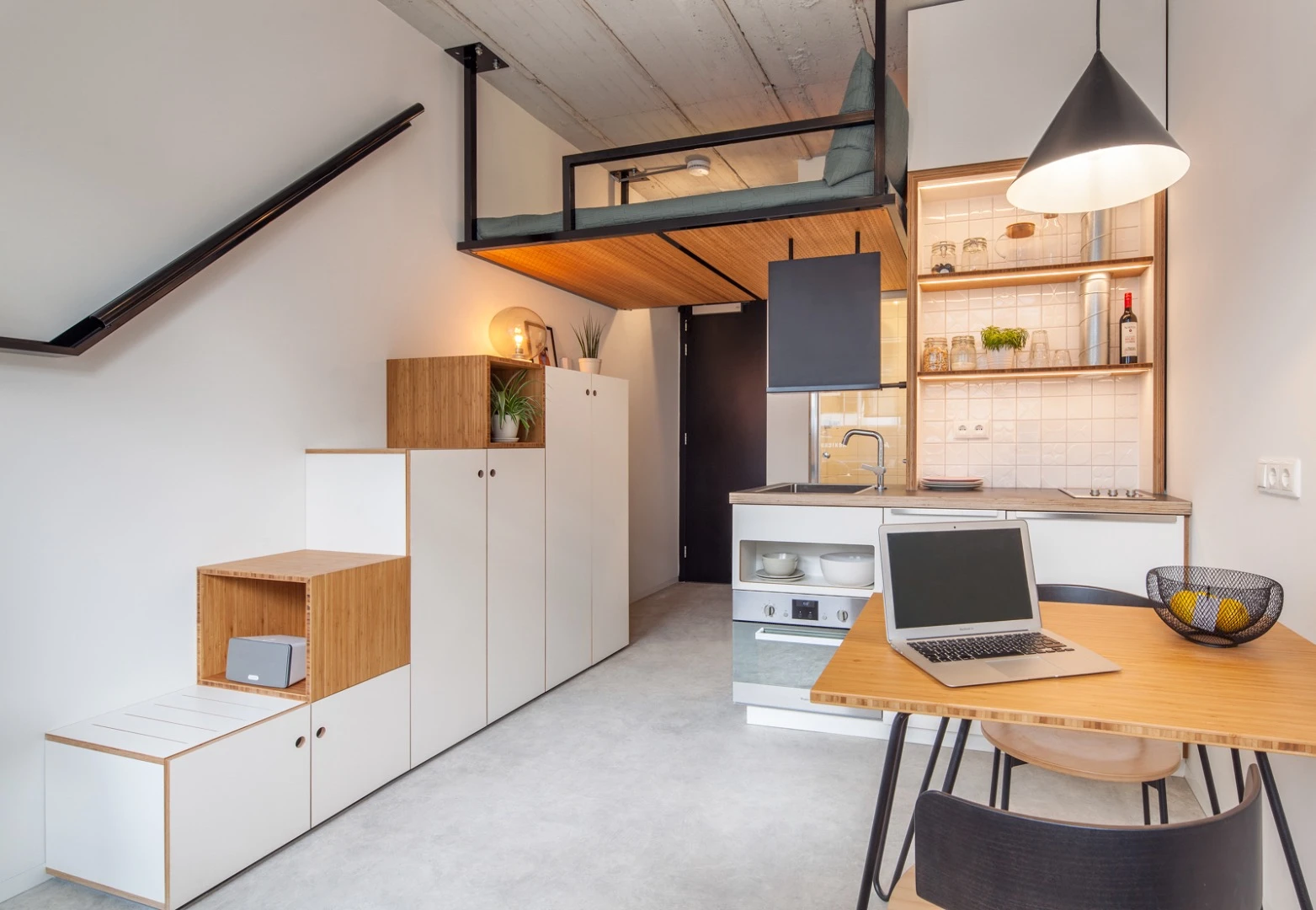 Students reach the loft sleeping area by climbing atop a storage unit