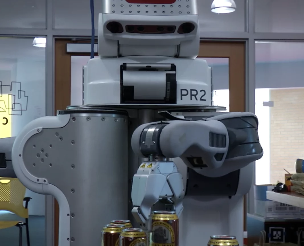 The humans would push a button on the robot to request a drink, prompting the robot to return to the "bar" where a PR2 robot was waiting to dispense cans of beer